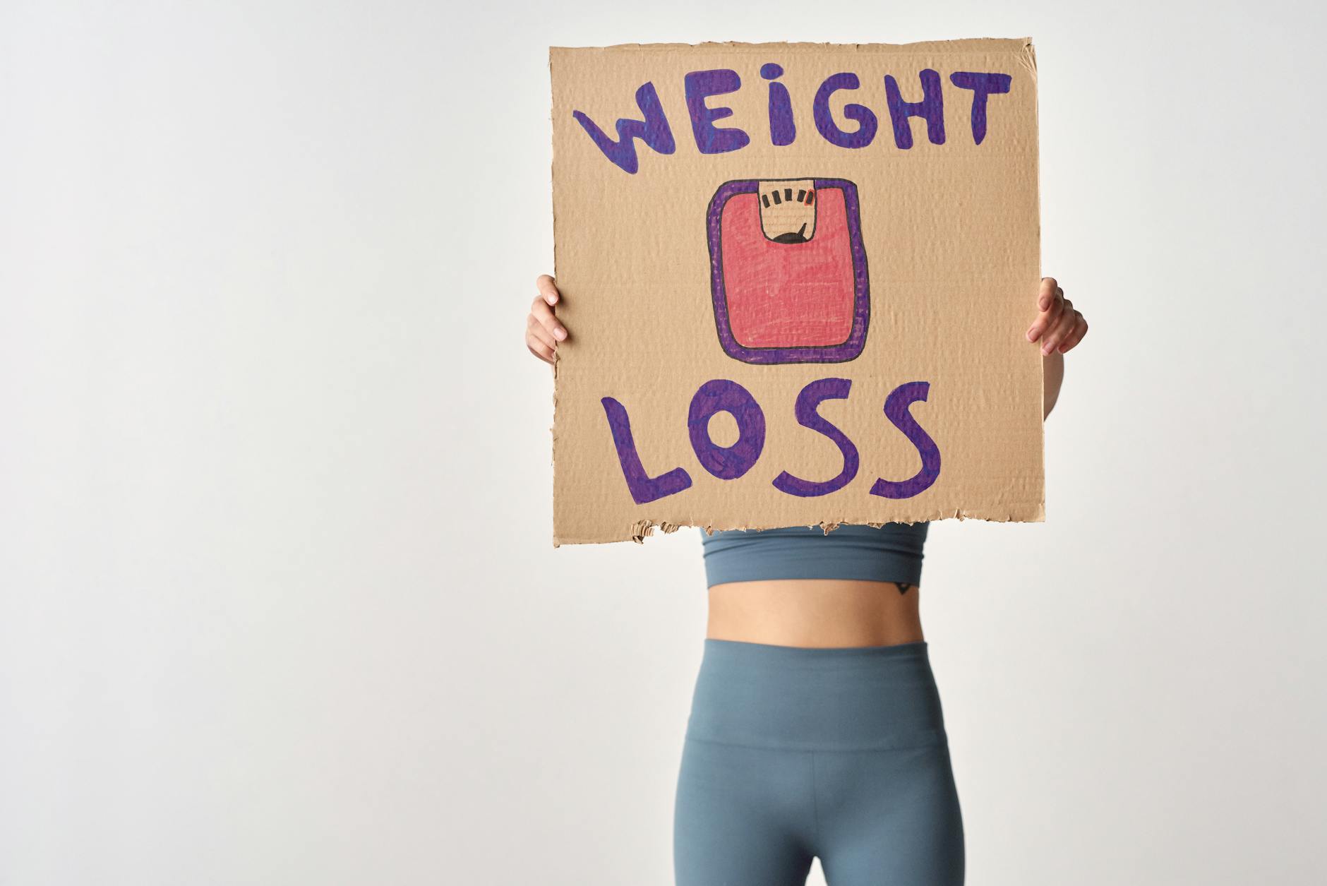 https://www.pexels.com/photo/person-holding-a-cardboard-with-weight-loss-message-6670943/